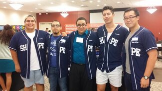 Five fraternity members in their chapter jerseys with arms around each other