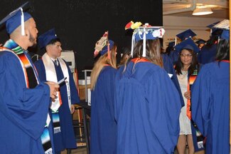 Group of student talking and wearing graduation robes and attire