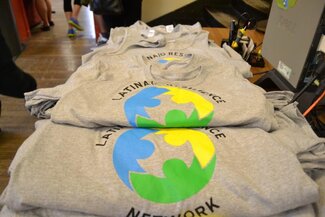 Stacks of grey t-shirts with Latina/o Resilience Network logo